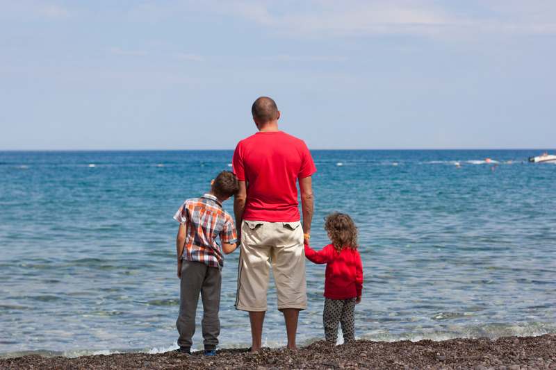 dad and kids by the sea