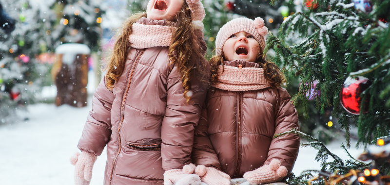 little girls in pink jackets in the snow