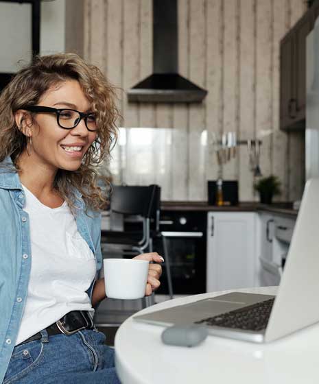 woman with coffee at computer