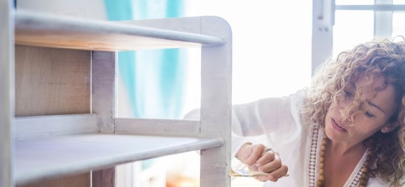 woman painting furniture