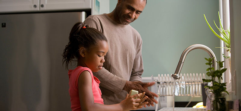 father and daughter at sink