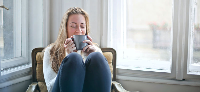 blonde woman sipping coffee